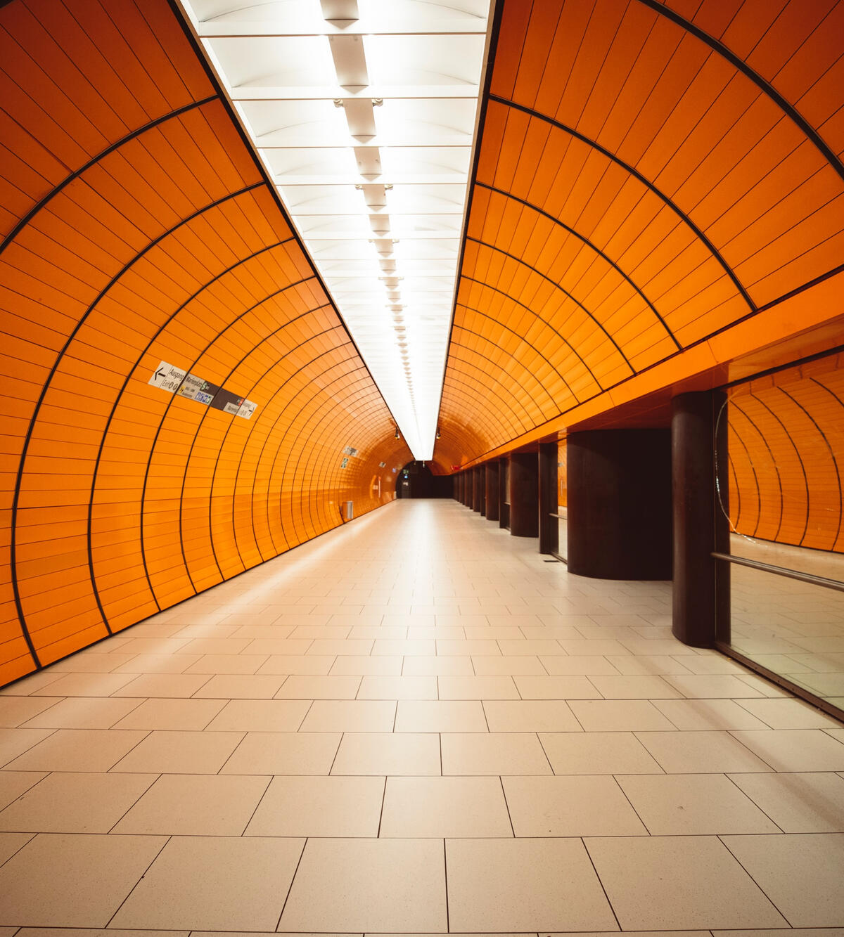 Orange interior of tube station in Germany, from german advertising paid media agency