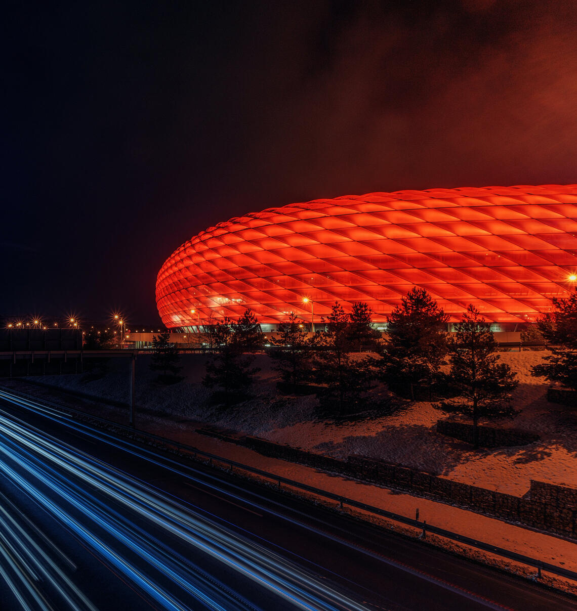 Exterior of Alianz stadium, red glass reflection, from german advertising paid media agency